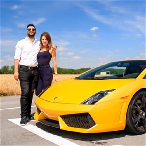 couple with supercar